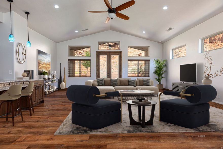 Beautifully updated home in the highly desirable La Estancia community of Kanab. Originally built in 2018 and thoughtfully refreshed in 2025, this 3-bedroom, 3-bath residence offers 2,512 sq ft of contemporary living framed by Southern Utah's striking red cliff scenery. The exterior boasts brand-new stucco accented with timber beams, a terraced front landscape, and multiple outdoor spaces including a covered patio, open terrace, and inviting fire pit area-all perfectly positioned with dramatic cliffs rising behind the home. Inside, the open-concept great room and dining space connect seamlessly to the outdoors. The kitchen features new granite countertops, updated appliances, and two oversized pantries. The primary suite includes private patio access, a custom tile shower, and a spacious walk-in closet. The finished basement offers two additional bedrooms, a full bath, and a large family room ideal for gatherings. A circular driveway and 3-car drive-through garage add both function and curb appeal. La Estancia residents enjoy resort-style amenities including indoor and outdoor pools, a fitness clubhouse, dog park, pickleball courts, and scenic walking trails. Conveniently located within walking distance to parks, dining, and local amenities. Buyer to verify all information.