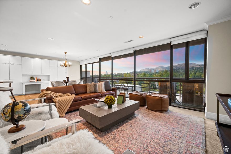 Experience elevated city living in this rare 3,300 sq. ft. residence on the 7th floor of Governor's Plaza. Originally designed as two units, this spacious home now offers a flexible layout with 3 bedrooms, 2.5 bathrooms, a large living room, and a separate family room-ideal for both entertaining and comfortable everyday living. From sunrise to sunset, enjoy breathtaking 180-degree views of the Salt Lake Valley, downtown skyline, and surrounding mountains through expansive floor-to-ceiling windows and multiple balconies. The bright kitchen and dining spaces flow seamlessly to the living areas, creating a warm yet sophisticated environment. The bedrooms, including a generous primary suite, provide privacy and a quiet retreat. For convenience and peace of mind, the residence includes four secure garage parking spaces and all the amenities of low-maintenance condominium living. Perfect for those looking to downsize from a larger home without sacrificing space, style, or comfort, this one-of-a-kind property offers an effortless lock-and-leave lifestyle in the heart of Salt Lake City.