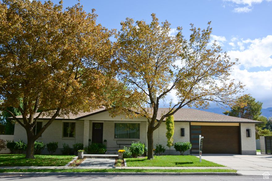 Completely renovated 1978 Ranch Rambler located in easy access location in South Jordan. Welcome to 9837  a fully renovated home with thoughtful upgrades inside and out. The exterior boasts newer paint, a shaded front patio, custom lighting, dual-hinged RV gate, and low-maintenance landscaping with mature trees, steel planters, and a sunken fire pit. A spacious wood deck with a natural gas fireplace and Cabo Beach stone surround make the backyard an entertainer's dream.  Inside, the main level offers a reimagined 21st-century craftsman layout with LVP flooring, Restoration Hardware lighting, a high-end kitchen with stainless steel appliances, alder cabinetry, and a custom island. The primary suite features pendant lighting and a spa-like bath with a soaking tub.  The fully finished basement includes a private entrance, full kitchen, laundry, and large bedrooms-ideal for multi-generational living or rental potential. The oversized 2-car garage features 220v service, cabinet lighting, storage for 60+ totes, and natural gas plumbing for heat.  With modern mechanicals, updated electrical/plumbing systems, and attic/basement insulation, this home is not only stylish but energy-efficient and future-proof