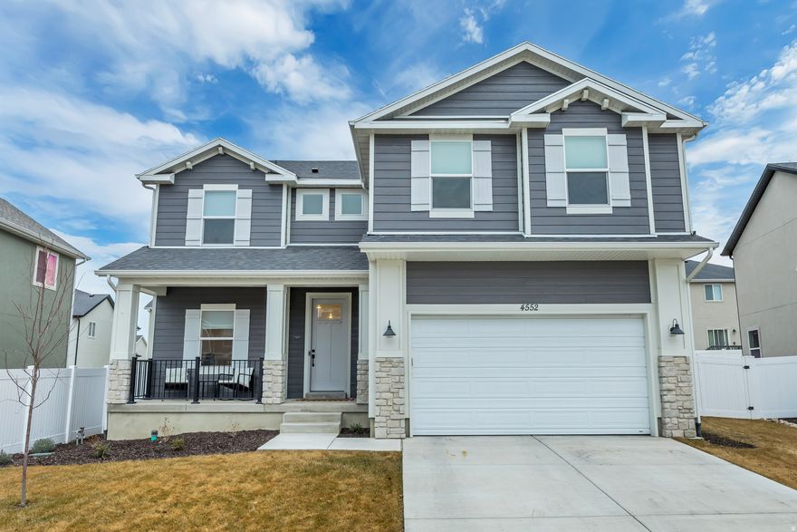 This beautiful, only one-year-old two-story home offers timeless traditional curb appeal paired with modern finishes and breathtaking mountain views. The main floor features durable LVP flooring throughout and an expansive gathering space perfect for entertaining or everyday living, along with a versatile formal front room ideal for an office or sitting area and a convenient half bath. The bright kitchen is the heart of the home, showcasing a spacious island, crisp white cabinetry, quartz countertops, and stainless steel appliances. Upstairs, you'll find a comfortable loft space, four well-appointed bedrooms, and a conveniently located laundry room. The generous primary suite provides a relaxing retreat with a large bedroom, dual sinks, a separate soaking tub and shower, and an oversized walk-in closet designed for optimal organization. Outside, enjoy a fully landscaped and fenced yard complete with charming planter boxes-perfect for gardening, gatherings, play, pets, or simply taking in those stunning mountain views.