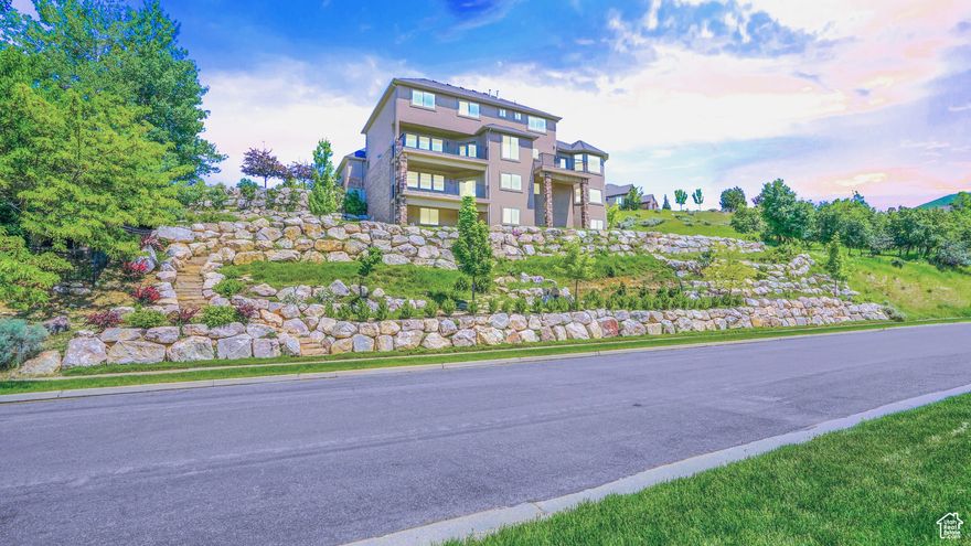 Welcome to elevated living-where luxury meets legacy. Perched high on the east-bench hills of Bountiful, this extraordinary four-level estate is the crown jewel of the prestigious, desirable community of Temple Ridge. Inspired by elegance this architectural masterpiece spans over 10,000 square feet and offers commanding, panoramic views of the Great Salt Lake and Antelope Island. This stately residence features six expansive bedrooms, including two luxurious primary suites, a junior suite, and three additional bedrooms that rival the size of most master suites. Recently updated with plush, high-end carpeting throughout, the home blends timeless sophistication with modern comfort. The lower level is ideal for grand-scale entertaining, boasting a ballroom-sized living area adjacent to a theater room ready for custom design. An additional basement level offers even more potential, all framed by the same breathtaking views seen from nearly every room. Located just 15 minutes from downtown Salt Lake City and the international airport, this one-of-a-kind property offers the perfect balance of seclusion and convenience. This estate home may also be purchased with the adjacent lot (1735 S. Temple Court) for a total of $3.5M. Some photos have been virtually staged Buyer/;Broker to verify all.