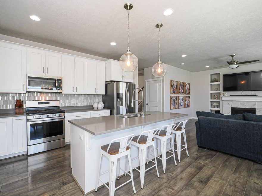 AMAZING HOME WITH FULLY FINISHED BASEMENT AND PAID-OFF SOLAR PANELS!  Awesome main level features an open layout and wide plank LVP flooring. Beautiful kitchen showcases a large island, white cabinets, quartz countertops, & stainless-steel appliances. Comfortable family room with built in shelving & gas fireplace. Large office with wainscoting accent wall | Upstairs you'll find a relaxing primary suite with vaulted ceilings, separate tub/shower, double sinks, & large walk-in closet | 3 additional bedrooms, full bathroom, loft, & large laundry room complete the 2nd level | Fully finished basement with 2 additional bedrooms, full bathroom with double sinks, additional family room & storage room | Private backyard with views and no direct back neighbors | Epoxy finished garage floors | Great Bluffdale location close to parks, walking trails, schools, & easy freeway access.