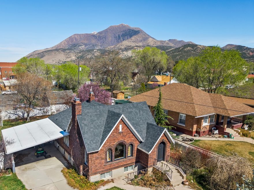 Opportunities like this do not come around often. Located in the Central Commercial (CC) zone in the heart of downtown Nephi, this property offers true mixed-use potential. Currently used as a residence, it opens the door to a live/work lifestyle where you can run a business while enjoying the comfort and charm of home all in one place.  The 1940s Tudor-style design brings undeniable character with its gable rooflines, arched doorways, and storybook curb appeal, creating a warm and inviting space that stands out for both residential living and business presence. Inside, the home offers a spacious and functional layout with multiple bedrooms, flexible living areas, and a basement with a separate exterior entrance, ideal for separating personal and business spaces if desired.  The CC zoning allows for a wide range of uses, making this an ideal setup for those looking to combine lifestyle and livelihood. Some of the most fitting live/work opportunities for this property include a boutique retail shop, art gallery or studio, professional office space, counseling or therapy services, salon or spa, bakery or small caf setting, photography studio, instructional or creative academy, specialty craft or hobby shop, or a small business storefront with residential living.  The private, fully fenced yard with mature landscaping and pergola adds an extra layer of versatility, offering space for outdoor gatherings, client experiences, or simply a peaceful retreat at the end of the day.  Positioned within walking distance to local shops, restaurants, the coffee house, post office, county offices, and the DUP museum, the location supports both strong visibility and everyday convenience.  Whether you are looking to create a unique business presence, invest in a flexible property, or enjoy the benefits of living where you work, this property delivers character, location, and opportunity all in one.