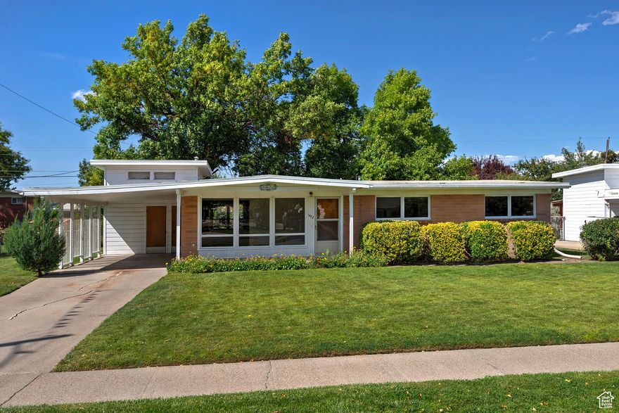 This charming rambler offers single-level living with immense potential for your personal touches and updates. Perfect for comfortable everyday living, it features three bedrooms and two bathrooms, with large windows that invite an abundance of natural light throughout the home. The property sits on a generously sized, fully fenced lot, providing a private outdoor space and peace of mind. Covered parking adds convenience and protection for your vehicles. Location is a standout, with easy access to schools, shopping, restaurants, and entertainment options, making this home a thoughtful choice for buyers seeking both practicality and opportunity.