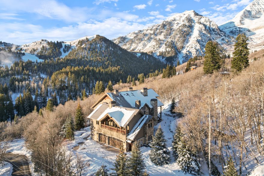 Introducing Deer Crest Lodge: a timeless, heavy-timbered estate less than a half mile from Sundance Mountain Resort.   Boasting one of the most spectacular locations on the mountain, this architecturally designed home has 3-story views of Mount Timpanogos on one side, and unobstructed panoramic views of Sundance's front mountain on another.   From several places in the home one can watch skiers coming down Stampede, and enjoy the beautiful ambiance of the mountain lit up for evening snow sports.  Deer Crest is also positioned on a rise adjacent to the neighborhood's private hiking trail to Stewart Falls, with coveted green space on multiple sides of the property line.  The exquisite construction of this smart home has to be seen in person to appreciate, with features such as a two-story library, golf simulator room set up by Jack Nicklaus, steamed French beechwood doors and interior moldings, eleven fireplaces, cedar sauna, and exterior river water feature, to name a few. Meticulously crafted and lovingly cared for by some of Sundance's most beloved full-time residents since 2012, this home has been, and will continue to be, the centerpiece of bringing family and friends together to experience one of the most beautiful settings on earth.   Note: The new roof will be completed February 15th, after which more exterior photos will follow.