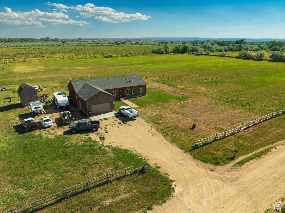 Horse Property!! Between Myton and Bridgeland! Very private 9.08 fenced acres with 10 shares BIA water! Flood Irrigated, currently in grass hay. The home has 4 bedrooms and 2 baths! It is an open floor plan with central living, dining, kitchen, and family room! It is heated with electric forced air and also has a fireplace in the living room and a woodstove in the family room. The master bedroom/bathroom is large and in the southeast corner of the home for lots of sunshine! The living room opens on to a nice big patio outside for barbecues and parties in the back yard! The attached 2 car garage has plenty of floor space, room for workbenches, and extra height for some storage! The property is near the Duchesne River and attracts all kinds of wildlife! Give us a call!