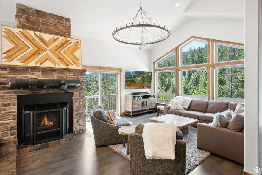 Experience mountain living at its finest in this spectacular mountain-modern home, perfectly positioned on one of the sunniest, south-facing lots in coveted Summit Park. Floor-to-ceiling windows in the open great room frame sweeping mountain panoramas and flood the space with natural light, creating an inviting atmosphere for both everyday living and effortless entertaining. Gleaming hardwood floors and granite countertops flow throughout the main level, anchoring a gourmet kitchen outfitted with a Wolf cooktop that any home chef will love. Every modern convenience has been thoughtfully integrated to enhance comfort and efficiency. Dual A/C units keep the home cool on warm summer days, while a brand-new roof (2023) and commercial-grade heat tape ensure year-round reliability. Underneath it all, you'll find a new tankless water heater with recirculator, reverse-osmosis system, and water softener, alongside a built-in central vacuum system and custom luxury solar shades. A dedicated electric car wall charger in the oversized three-car garage complete with 16ft ceilings & abundant crawlspace storage round out this homes updated amenities. Retreat to the dramatic master suite, where your own stone fireplace, private balcony, and breathtaking views await. Three additional spacious bedrooms and four designer bathrooms provide ample room for family and guests. Step outside to your private oasis: an exquisitely landscaped backyard anchored by a high-end saltwater hot tub next to an outdoor gas fireplace, all tucked away for complete seclusion. Outdoor enthusiasts will appreciate that this home is within walking/biking distance of some of Park City's best trail networks, and offers easy access to incredible back-country skiing opportunities right from your doorstep. Whether you're relaxing by the fire inside, soaking under the stars, or planning your next slope-side adventure, this home delivers uncompromising luxury, comfort and that irresistible Summit Park ambiance.