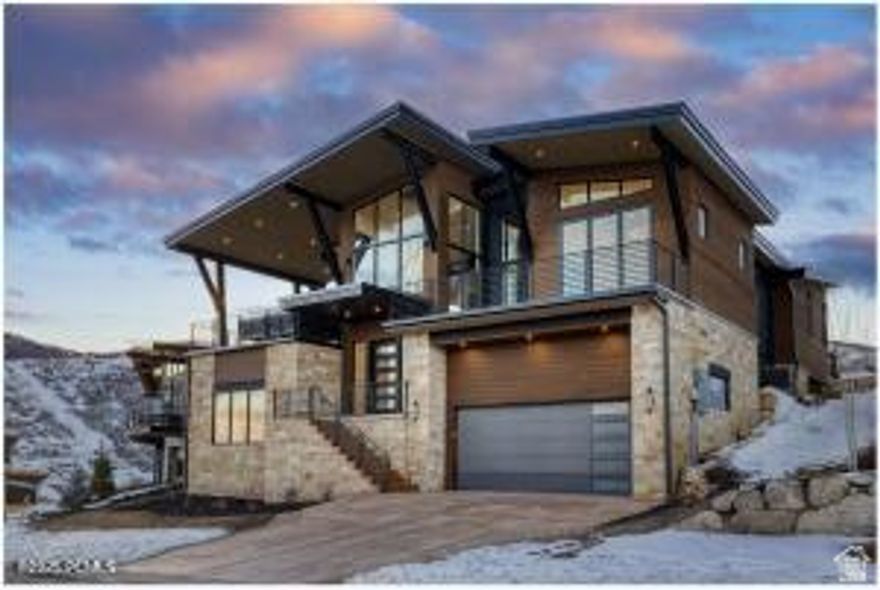 This brand new exquisite 5-bedroom, 5.5-bathroom luxury home in SkyRidge is nestled across from the new Deer Valley East Village, offering breathtaking views of both the lake and the  ski slopes. With open space across the road, lake and ski run views will always be right outside your window. Designed for both comfort and elegance, this new custom home comes with top of the line appliances and finishes and is outfitted with a large hot tub. The grand see-through fireplaces in great room and main level primary suite,  custom granite, tile and elegant hardwood floors harmonize to create this luxurious retreat . The expansive open-concept living and dining areas are perfect for entertaining, featuring floor-to-ceiling windows and sliding glass doors that open to a large deck. Enjoy the serene mountain atmosphere complete with a barbecue area, fire pit and ample seating for outdoor dining and relaxation. The state-of-the-art kitchen is a chef's dream, equipped with high-end appliances, a butler's pantry, custom cabinetry, and a large center island. Five beautifully appointed bedrooms- 4 with en-suite bathrooms, offer privacy and comfort.  The master suite boasts a deck overlooking the lake, a spa-like bathroom with a soaking tub, and a spacious walk-in closet with owner's lock out. The lower level includes a spacious great room/game room with a wet bar,  and a relaxing outdoor hot tub, perfect for unwinding after a day on the slopes or on the trail. The garage boasts built in storage, a tandem bay, and storage closet. Radient driveway, front steps and bathrooms. Situated just steps away from world-class skiing at Deer Valley this home offers unparalleled access to the best that the resort has to offer with the HOA shuttle service. Whether you're looking for a personal getaway or a high-performing rental property, this home offers the best of both worlds. Don't miss this amazing opportunity to own this beautiful home in SkyRidge.