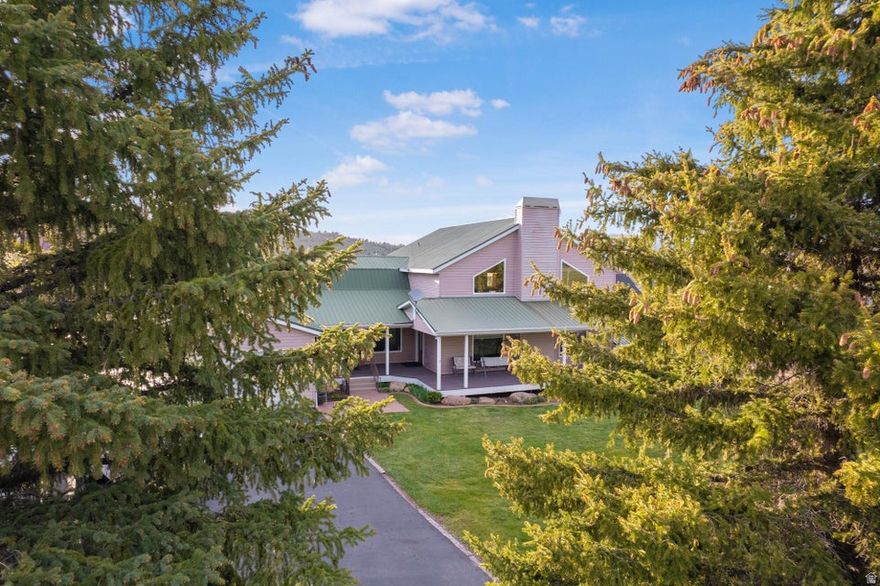 Located in the heart of beautiful Pine Valley, this spacious mountain property offers the perfect combination of comfort, functionality, and year-round living. Originally built in 1986 and extensively expanded and renovated in 2006, the home now features 4,425 sq ft with 5 bedrooms and 5.5 bathrooms, providing plenty of room for full-time living, vacation use, or hosting large groups of family and friends. The thoughtful addition created a massive family room designed for gathering and relaxing, complete with a cozy wood-burning stove that adds warmth and mountain charm. Large windows throughout the home bring in natural light and capture the surrounding mountain setting, creating an open and inviting atmosphere. Multiple living spaces give everyone room to spread out while still maintaining a comfortable and functional layout. The kitchen and dining areas flow well for entertaining, while the generous bedroom count and multiple bathrooms make the home ideal for guests or multi-generational living. Downstairs, the basement offers its own private access along with another wood-burning stove, making it a great setup for additional living quarters, recreation space, or private guest accommodations. A huge basement storage room provides exceptional space for gear, seasonal storage, tools, or hobby space. Outside, enjoy the well-maintained lawn and yard surrounded by Pine Valley's cooler mountain climate and peaceful setting. The attached 2-car garage offers convenient parking and storage, while additional parking space provides room for trailers, toys, or guests. Located on a paved street with year-round accessibility, this property combines mountain living with everyday convenience.
