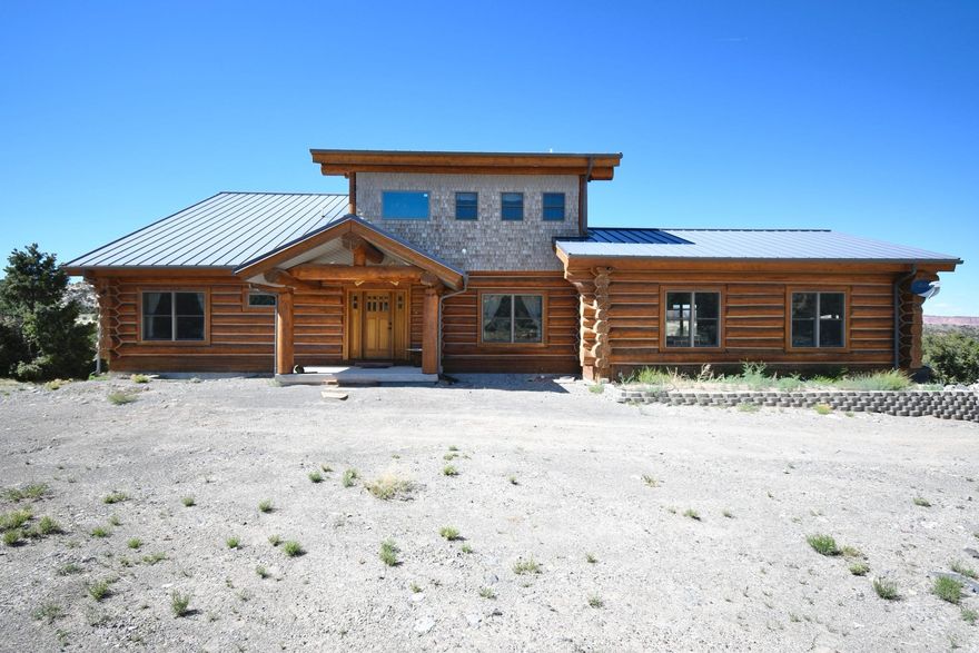 *** SELLER FINANCING AVAILABLE ***Nestled on 12.34 acres of natural landscape in the serene and picturesque Teasdale, Utah, this stunning log home offers the perfect blend of rustic charm and modern comfort. With three spacious bedrooms and three well-appointed bathrooms, this residence is ideal for those seeking a tranquil retreat or a luxurious primary residence. The home boasts huge vaulted ceilings that create an open, airy ambiance throughout the living areas. The large windows let in abundant natural light and offer breathtaking views of the surrounding landscape. A huge deck spans the back of the home, providing ample space for outdoor entertaining, relaxing, and soaking in the stunning views. Additionally, a private hot tub offers the perfect spot to unwind after a long day. The oversized kitchen is a chef's dream, featuring modern appliances, ample counter space, and custom cabinetry. It's designed to accommodate both everyday meals and large gatherings. The master bedroom is a true retreat with its own private balcony offering privacy and comfort. The basement has a double glass garage door to store all your toys. This remarkable log home combines the best of rustic and contemporary living, making it a unique find in Teasdale. Whether you're enjoying a quiet evening on the deck, entertaining friends in the spacious kitchen, or exploring the vast acreage, this property promises an unparalleled lifestyle. The property is surrounded by a pristine natural landscape, offering peace, privacy, and the opportunity to enjoy the great outdoors right at your doorstep. Close to great fishing, hunting, ATV trails, and hiking. Don't miss the chance to own this exquisite piece of paradise. Schedule a viewing today and experience the magic of this log home for yourself!