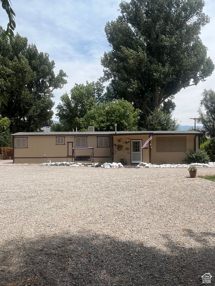 This charming little home is nestled in the beautiful town of Marysvale that everyone either comes to visit and ride side by sides or falls in love with and moves in permanently. There are shade trees as well as apple trees surrounding this property for great shade. This home is completely fenced in with a sprinkling system and an extra building in the back that can be used for rental property. This property also has an extra water meter in the back corner that makes this property able to be subdivided into two sections or more. There are two sheds in the back that can be used for storage and another that is new that can be used as a shop..  The property is surrounded by beautiful mountains and the Sevier River within walking distance for floating or fishing or kayaking. A great property for a family to live permanently or a second vacation home.. Lots of parking for vehicles and 4 wheelers.. There is also alot of parking for RVs and storage..This is a Gem you must see..