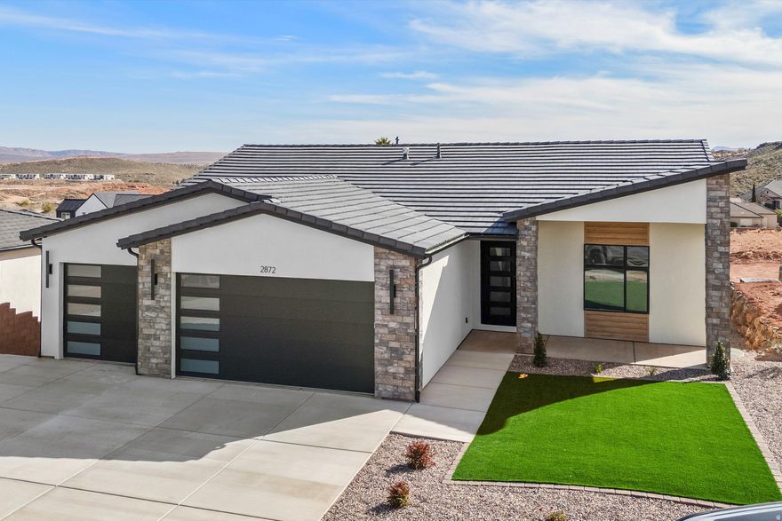 Stunning 2026 new construction in the desirable Coral Canyon community of Burke Springs in St. George! This modern home features 6 bedrooms, 4 bathrooms, and a private ADU-ideal for guests, multi-generational living, or rental income. Eye-catching contemporary exterior with stone accents . Inside, enjoy a bright, open-concept layout with spacious living areas perfect for entertaining. The kitchen flows seamlessly into the main living space, creating a welcoming and functional design. Thoughtful finishes and quality craftsmanship throughout. Low-maintenance desert landscaping, generous driveway, and ample garage space. Conveniently located near golf, hiking, and all the outdoor recreation Southern Utah is known for. A rare opportunity to own a versatile, move-in-ready home in one of St. George's most sought-after communities!