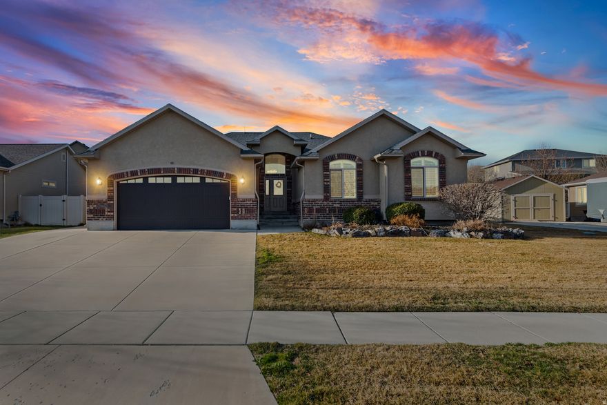 Situated on the quiet north slope of Lake Mountain, this Saratoga Springs home offers a bright and spacious open floor plan with vaulted ceilings and a welcoming tiled entry. The kitchen features knotty alder cabinetry, quartz countertops, a large pantry, and ample counter space, and flows easily into the dining area and living room with a cozy gas fireplace and plenty of natural light. The main floor primary suite includes a large walk-in closet, garden tub, and separate shower. The lower level provides generously sized bedrooms, a large family room perfect for gathering or entertaining, and cold storage. Enjoy the covered back patio with a peek of Mt. Timpanogos, along with an RV pad, storage shed, and space for gardening. The furnace and A/C were replaced in 2022. Located within walking distance to local schools and the Saratoga Springs Utah Temple, and surrounded by trails and parks. Conveniently close to Utah Lake access, TalonsCove Golf Club, and everyday shopping.