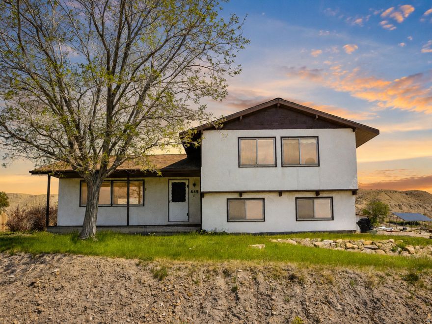 Perched on a hillside overlooking peaceful farmland and wide-open views, this 4 bedroom home is full of potential and ready for its next chapter. Sitting on nearly an acre, the terraced yard offers endless possibilities to create an incredible outdoor space while enjoying the privacy and scenery this unique property provides.  Inside, you'll find beautiful hardwood floors, a cozy coal-burning fireplace, and large closets throughout. The home has been professionally cleaned, including the carpets, making it move-in ready while you plan your own updates and personal touches.  Additional features include a walkout basement, charming front porch, pull-through driveway, and a large shop with electricity and plenty of room for storage, hobbies, or projects. Whether you're looking for space, views, or the opportunity to create something truly special, this property offers it all.  Square footage figures are provided as a courtesy estimate only .  Buyer is advised to obtain an independent measurement.