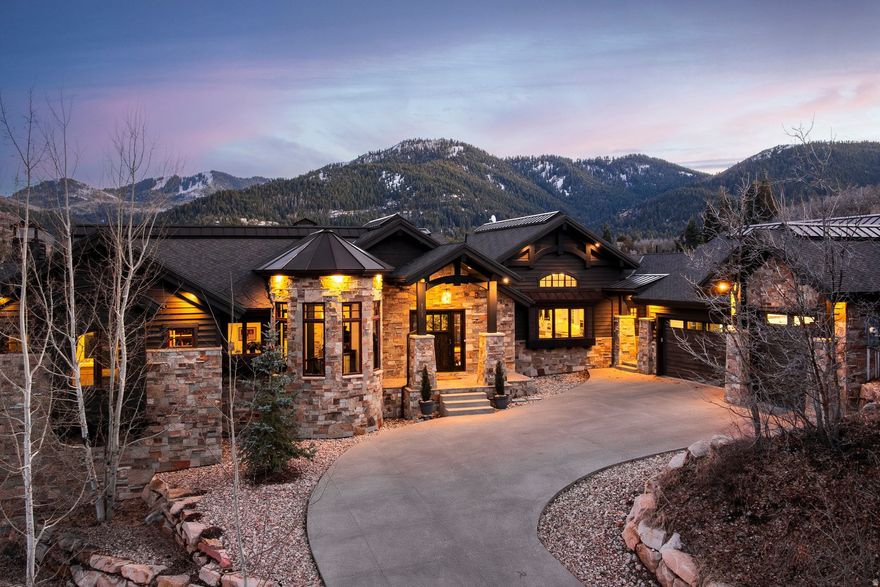 Tucked at the end of a quiet cul-de-sac in a gated community, this exceptional home offers privacy, open space, and seamless access to both Park City and Salt Lake City. Designed for effortless living, the main level features a beautifully appointed kitchen with a Thermador appliance suite, walk-in pantry, and easy flow to the mudroom, laundry, and oversized garage. The functional floor plan includes a lower-level walk-out with three guest suites, a second kitchen/wet bar, game room, and media space, ideal for entertaining. Elevated finishes of stone, slab countertops, hardwood floors, and exposed beams create a warm yet refined mountain aesthetic. Enjoy a private outdoor retreat with a covered hot tub, firepit, and tranquil water feature. A rare oversized garage accommodates up to four vehicles, including Sprinter or RV, with epoxy floors, storage, and dog wash. Quiet, scenic, and move-in ready.