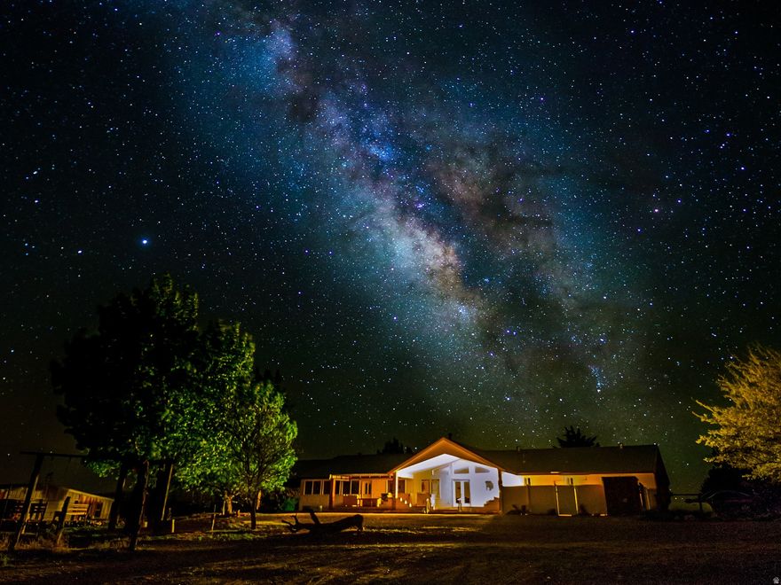 This incredibly unique 20-acre property is truly unlike anything else in Southern Utah and the greater Lake Powell region. Offered turnkey and ready to move in, fully furnished and well appointed. The ranch has seen extensive recent remodeling, fresh paint, and thoughtful additions throughout, blending modern comfort with the charm and functionality of a true southwestern ranch estate. Mature fruit trees, flexible animal-friendly zoning, a private well, and abundant water rights create an exceptional environment for those seeking space, privacy, and the ability to truly grow and sustain. The established orchard includes grapes, apples, mulberries, pluots, peaches, apricots, and pomegranates, making this property as productive as it is beautiful. A newly redesigned portion of the home is a fully licensed AirB&B rental and features a private entrance and private kitchen. It is currently the closest licensed AirB&B to the world-famous Wave, offering immediate income potential in one of the most sought-after destinations in the region. With the current owners offering to help manage the property at a low cost, this is a rare opportunity to step into a truly turnkey oasis with limitless possibilities. Adding to the property's character, the ranch includes a genuine hand-crafted Mongolian yurt, built in Ulaanbaatar and thoughtfully placed within the landscape. Nearby, a carefully constructed circular arrangement of massive stones has been intentionally designed in astronomical alignment, marking significant celestial events such as solstices and equinoxes. These unique features create a powerful sense of place and connection to both land and sky, offering spaces for gathering, reflection, or retreat. Adding to the appeal, the ranch is surrounded by world-class outdoor experiences and located just 10 miles from the world-renowned Amangiri Resort. From iconic hiking trails, slot canyons, and red rock adventures to nearby national parks and Lake Powell's stunning waters, this property serves as a perfect escape into Southern Utah's Canyon Country.  The Page Airport offers daily flights to Phoenix and has several Executive FBO's to accommodate private aircraft, providing surprisingly easy access for both personal and recreational travel. This property truly sits at the crossroads of natural beauty, adventure, and Western lifestyle. You have to see it in person to understand how special it is. Call now to set up your private tour. Square footage figures are provided as a courtesy estimate only and were obtained from appraisal. Buyer is advised to obtain an independent measurement.