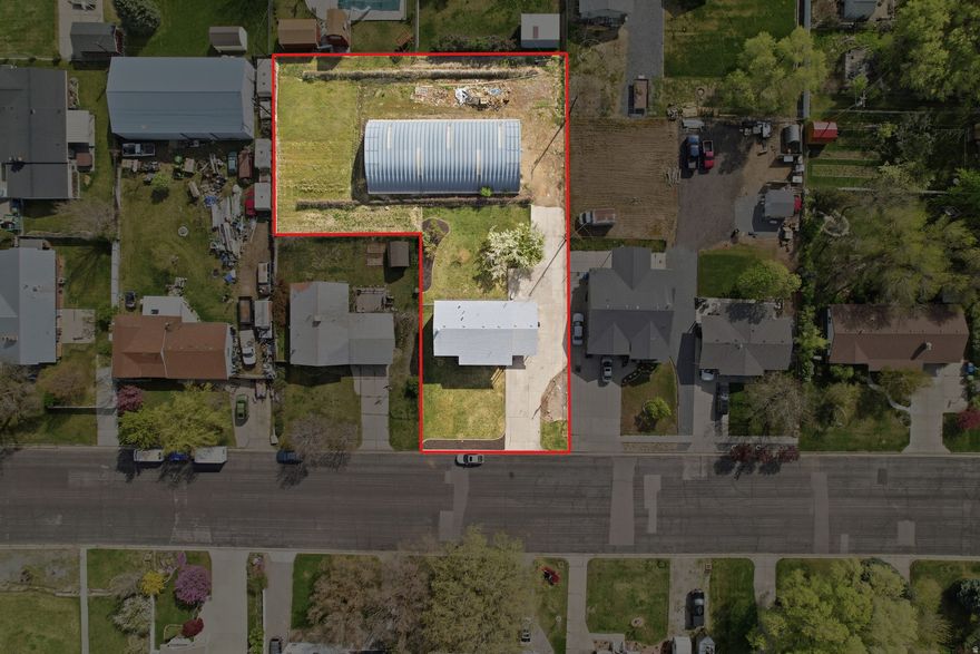 This incredible 4-bedroom, 2-bathroom home offers a rare combination of space, functionality, and future potential. Situated on two separate tax parcels 03-086-0073, the property includes both the home and a massive Quonset hut/shop-perfect for anyone needing serious workspace, storage, or hobby space. If you've been searching for a property with a large shop, your search ends here. The additional parcel provides flexibility and long-term value that's hard to find. Inside, you'll find an updated kitchen featuring newer cabinets and granite countertops, along with a comfortable, move-in-ready layout. The basement is 100% unfinished, giving you a blank slate to build exactly what you want. With plumbing already stubbed for a bathroom, there's excellent potential to add two additional bedrooms, a full bathroom, a family room, and extra storage-instantly increasing both livable space and value. Outside, enjoy fruit trees, grapes and a valuable water share, adding both charm and practical benefit to the property. Opportunities like this don't come around often-this one won't last.