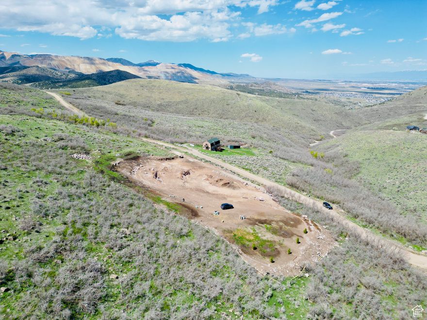 Prime building lot with subdivide opportunity-potential for up to 4 lots (buyer to verify). Includes permanent water meter (blue pipe feeds home), oversized water line for future ADU, and power stubbed with main and RV panels. Fiber conduit in place-live service plus potential second home feed. Septic system approved/permitted (Orenco deep-wall metered system). Lot is being leveled with compacted foundation base. Includes daylight basement home plans (~5,400 sq ft) featuring 9' ceilings on both the walkout basement and main level. East boundary runs to gully; west line follows treeline center. Buyer to verify all info. Call agent to walk property.