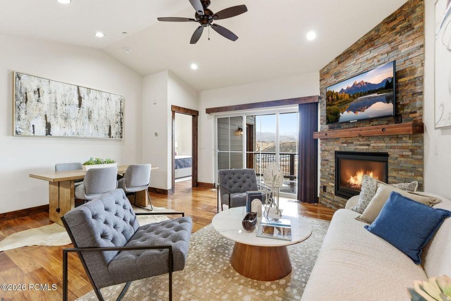 Elevated mountain living awaits in this upgraded 3-bedroom, 2,5-bath townhome in Black Rock Ridge, ideally located between Park City and Heber Valley. Just minutes to Deer Valley East Village, Park City Mountain, Jordanelle Reservoir, and Historic Main Street, this home offers year-round access to skiing, boating, hiking, biking, dining, and shopping.  Enjoy panoramic ski-area views stretching from Deer Valley to Canyons Village from your private lowe deck--complete with a 7-person hot tub for aprs-ski evenings. The open main level features vaulted ceilings, hardwood flooring, a gas fireplace, private deck, and seamless indoor-outdoor living.  The gourmet kitchen includes Jenn-Air appliances, granite countertops, gas range, and breakfast bar seating. The main-level primary suite allows for true single-level living and features a steam shower, and generous closet space.  Downstairs offers a spacious second family room, two additional bedrooms, a full bath, and ample storage--perfect for guests or flexible use. Additional features include air conditioning, programmable thermostat, high-speed internet availability, attached parking, and direct access to neighborhood hike/bike trails.  Located in the Jordanelle area with quick access to U.S. 40, this home is approximately 10 minutes to Park City's restaurants and boutiques, 5-7 minutes to Deer Valley skiing, and close to Black Rock Mountain Resort amenities.  Ideal as a primary residence, second home, or mountain getaway close to Utah's most sought-after recreation destinations.  Note: Some photos are virtually staged. Buyer also to verify square footage.