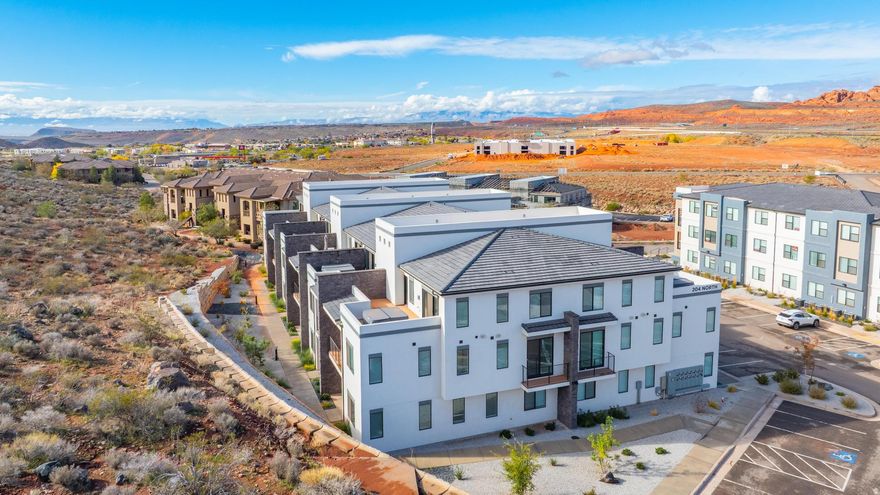 If you're looking for the ultimate Southern Utah getaway spot (or the perfect cash-flowing addition to your empire), congratulations - you just found it. This luxury end-unit townhome in the highly sought-after Terra Lofts comes fully approved for NIGHTLY RENTALS, which basically means it pays for itself while you're out living your best life. Step inside and you'll instantly feel like you accidentally wandered into a magazine photoshoot. Sleek modern design? Check. Open, airy layout? Check. Rooftop deck for sunset flexing, stargazing, or pretending you're in a music video? Big check. And if you're the adventurous type, you're minutes - literally minutes - from Zion National Park, Sand Hollow Reservoir, off-roading paradise, hiking, biking, and everything else Southern Utah is famous for. This location is elite. But wait... the amenities. THIS PLACE IS LOADED. We're talking amazing pools, a hot tub for post-hike recovery, and a legit waterslide that will make you question every life choice that led you to not buying this sooner. Bring your kids, bring your friends, or bring nobody because honestly... you deserve this. Whether you want to live here full-time, part-time, or just collect those sweet nightly rental deposits while you're chilling back home, this place checks every box. Opportunity is knocking. Loudly. Don't ghost it.