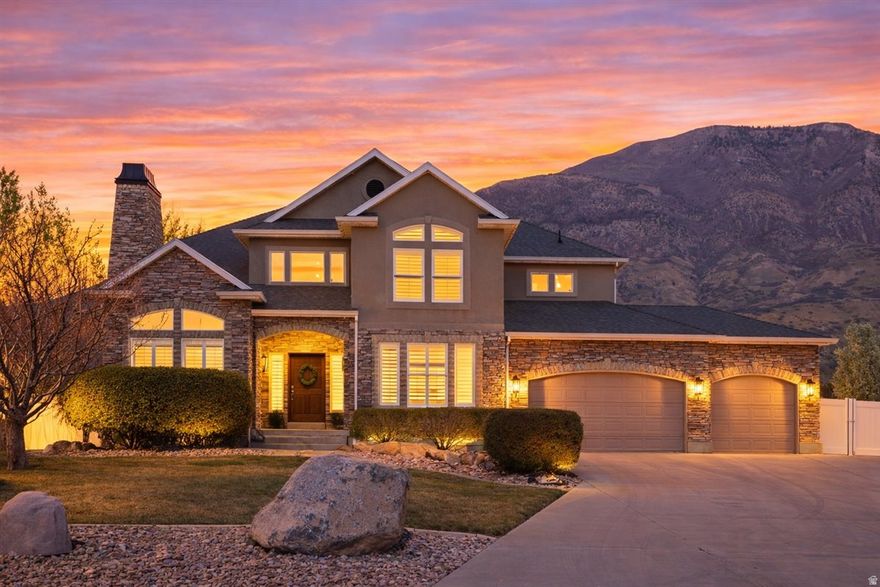 Welcome to your next chapter in luxury living, a beautifully crafted residence where timeless design meets modern comfort and scenic views.  Inside, a light-filled, open-concept floor plan showcases soaring ceilings, expansive windows, and rich hardwood floors. The gourmet chef's kitchen is the heart of the home, featuring custom cabinetry, premium stone countertops, an extra-large center island with seating, high-end stainless-steel appliances, and a spacious pantry. A unique bonus room off the kitchen is perfect as an additional office, homeschooling room, or children's playroom. The luxurious primary suite is a true retreat, thoughtfully positioned for privacy and relaxation. It boasts a generous bedroom with seating area and vaulted ceiling, a spa-inspired ensuite with a soaking tub, oversized walk-in shower, dual vanities, and a large walk-in closet. Three additional bedrooms upstairs are well-appointed and versatile-perfect for family, guests, or a dedicated home office. A favorite of the floorplan is the convenient large upstairs laundry room with built in cubbies and equipped with double washer/dryer hookups allowing ultimate efficiency. The fully finished basement feels light and modern. Built in mini-kitchen and multipurpose theater room are perfect for hosting family and friend hangouts. Two large bedrooms, and a third used as a workout room provide a great use of space. There is also a large storage room ready to be transformed into whatever is next on your wish list.  The professionally landscaped yard provides a serene mountain backdrop with lush greenery, mature trees, including 11 apple trees, and ample room for play or future amenities such as a pool or spa or pickleball court!  The private cul-de-sac location near great schools, the Murdock Trail, and American Fork Canyon is unmatched and perfect for year-round activities. Finding this combination of privacy, indoor/outdoor space, and location doesn't come available often!  All information, including square footage is deemed reliable but not guaranteed.  Buyer to verify.