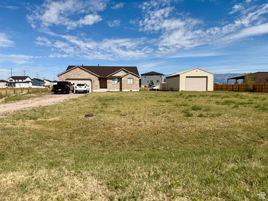 Custom-built ranch style home on 1 acre with 2 separate garages and a professional greenhouse Attached oversized 2-car heated garage plus a massive 28x60 detached garage/shop (approx.) with oversized commercial door, 220 power, cement floor and a greenhouse with misting system in the back room. Open floor plan with custom brickwork, vaulted ceilings and a spacious great room with semi formal dining. Main floor suite with oversized tub and full bath.