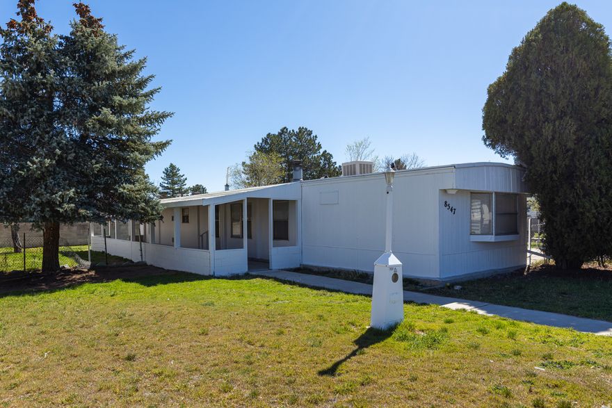 NICELY UPDATED MANUFACTURED HOME ON IT'S OWN LAND! Enjoy an Open Living Space with Two Generous Sized Bedrooms and Two Full Bathrooms.  You will Love the Oversized Two Car Garage with an Additional Storage Room.  This Home has a 576 Square Foot Covered Patio and a Fully Fenced Yard!  Close Proximity to Jordan Landing. Buyer to Verify All.