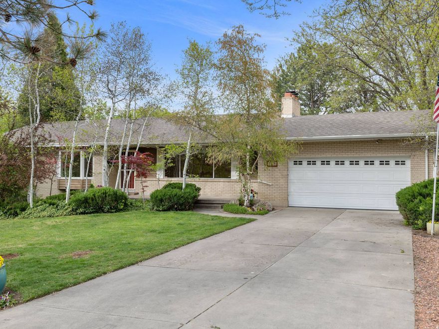 Enjoy this charming, brick rambler quietly nestled in a wonderful east Murray neighborhood! Perfect location and opportunity to customize and make your own! Clean, open layout, large windows with tons of natural light, spacious rooms, cozy fireplaces, primary suite, and ample closet and storage space throughout. Main-level, front room with closet and bay box windows could be a formal living room, or an enclosed office or bedroom with doors added. The finished lower level boasts a giant entertainment/playroom area, a den room equipped with a built-in bookcase and storage, and an extra bedroom and bathroom. You will absolutely love the walk-out access to your sprawling backyard (0.43-acre lot) that features a covered deck, covered and open patios, grassy space and garden areas, mature trees and privacy vegetation, beautiful landscaping, and gorgeous views of Mount Olympus and the Wasatch Mountains. Irrigation and well water available. Affordable utility services. Fantastic location within close distance to Murray City parks and sport fields, aquatic and recreation centers, and golf courses. Nature lovers and ski enthusiasts will appreciate the short distance to the multiple canyons and world-class ski resorts. Also, convenient access to local shopping, health facilities, and top schools within the Murray School District. Buyer to verify all information. Call today to schedule your personal tour!