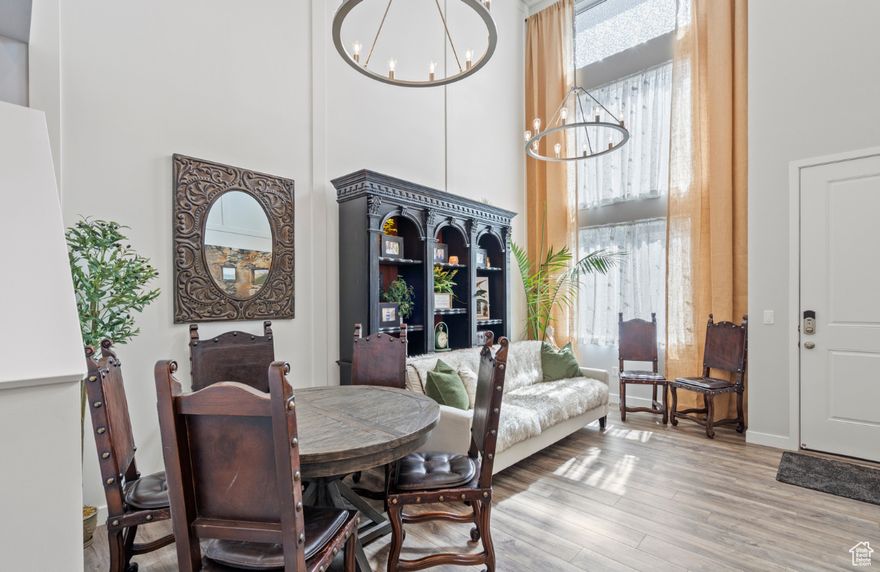 This impeccably maintained and MOVE-IN READY townhome is pure magic! Come see for yourself!   The whimsical floor plan lends well to a beautiful dance of sophistication, comfort, and functionality.  Enter through the front door into a great room with soaring 18-foot ceilings, thoughtfully designed accent walls, added LED recessed lighting, and striking twin chandeliers that create so much sparkle. Your new kitchen takes center stage with its custom tile backsplash, double-stacked soft-close cabinets, tons of prep space, gorgeous quartz countertops, a gas range, a matching refrigerator, and LVP flooring throughout.   This main floor also includes a convenient powder bath, basement access, and direct entry to the spacious two-car garage.  Up a winding stairway, you will find your own private retreat!  A versatile loft space and a gorgeous primary suite with raised dual-sink granite vanity, a custom-tile shower with a Euro glass enclosure, added overhead rain shower, and a walk-in closet. Both the loft and the bedroom are pre-wired and framed for adding ceiling fans.  On the third level - up another fun set of stairs - you will find three additional bedrooms, a full bathroom with granite and cultured marble finishes, a linen closet, and laundry room with gas dryer connection.   Major tech upgrades throughout: WiFi - controlled light switches, smart thermostats, ring doorbell, wifi enabled garage door opener, 50-amp outlet for EV charging, oversized 50-gallon water heater, and two separate furnace and A/C for max comfort and efficiency. The unfinished basement is your blank slate.  It is an excellent place for storage, obvious recreational or play space, and if you are ready to design your finishes, it is already partially framed and pre-plumbed for future bath, bedroom, and flex space.   Day Ranch subdivision is conveniently located between I-15 and Redwood Road, with schools, parks, trails, and green space, pickleball courts, and dog parks  just a short walk away. You will be only minutes from The Point, Bluffdale's exciting new mixed-use development. This home places you in the heart of an already thriving community.  Offers with seller financing are welcome. Square footage figures are provided as a courtesy estimate only.  Buyer is advised to obtain an independent measurement.