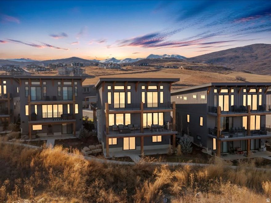 This lakefront home in The Escapes at Edgewater offers rare direct water views over Pineview Reservoir with the added benefit of short term rental zoning, blending lifestyle appeal with strong income potential. Featuring hardwood floors throughout, a chef focused kitchen with upgraded appliances including a premium range and built in refrigerator, quartzite countertops, and a prep sink ideal for entertaining. The primary suite is finished with marble countertops. The secondary baths and powder room features quartz for a cohesive look. Ensuite bathrooms for all upper level suites and a jack and jill bathroom for the lower level. Upgraded cabinetry adds storage and polish throughout the home. An integrated sound system serves the main level, basement media room, and outdoor deck. Enhanced floor and wall insulation improves year round comfort and sound management. It includes custom drapery in select upstairs bedrooms and the landing pairs with motorized shades throughout. Cozy up to two stone fireplaces anchoring the living spaces. With a closed in loft providing a dedicated office area. Enjoy the oversized sliding doors off the dining area, designed to maximize lake views.  Practical upgrades include a water softener, roof heat cable, epoxy coated garage floors, dual tankless water heaters, and electrical in place on the lower patio for a future hot tub. All located just 8 minutes to world class skiing at Snowbasin Ski Resort, home to the 2034 Winter Olympics, and 25 minutes to Powder Mountain Ski Resort. Square footage figures are provided as a courtesy estimate only and were obtained from floor plans. Buyer is advised to obtain an independent measurement.