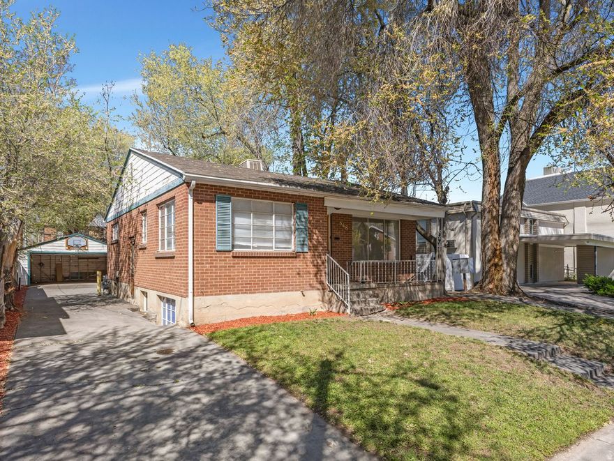 Darling bungalow in a fantastic location!  Nestled in a great neighborhood just a few minutes from Liberty Park and downtown living. This home features a spacious living room with beautiful hardwood floors and abundant natural light. The Kitchen has lots of counter space, gas stove and microwave, .  Two bedrooms are on the main level with a generously sized full bath. The lower level has a mother-in-law apartment featuring a separate entrance and includes family room, one bedroom, one bath, and a spacious kitchen-perfect for rental income or extended living.  Enjoy the large backyard!  PLUS, there is a two-car garage plus additional parking, which offers plenty of space for vehicles and storage.  It's a GEM!