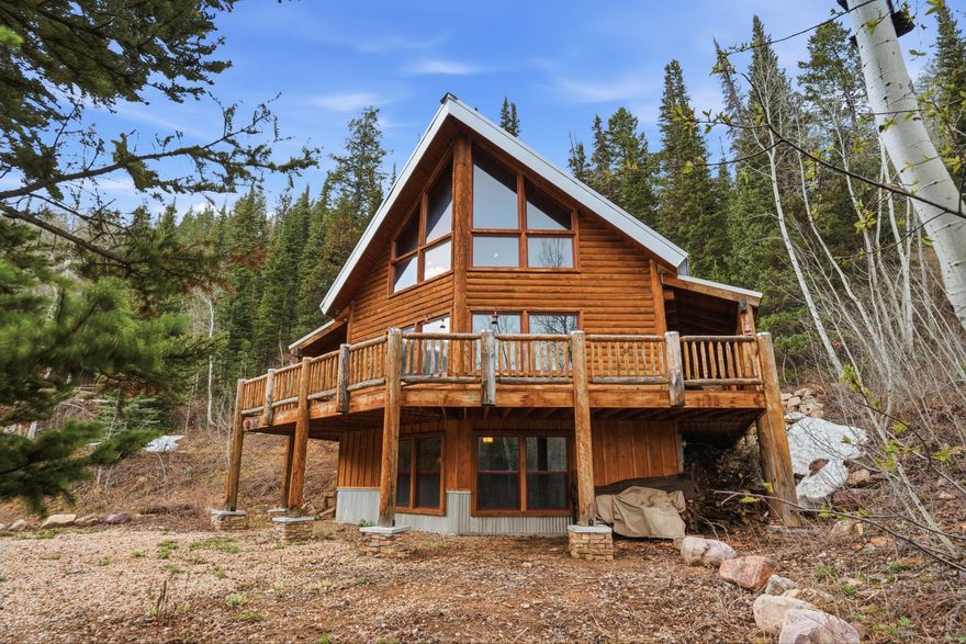 Nestled at the top of the coveted Pine Mountain cabin community just east of Oakley, UT, this impeccable 4-bedroom, 3-bathroom seasonally accessible retreat backs directly to HOA open space and national forest - offering privacy, serenity, and breathtaking natural surroundings. Newly constructed in 2013, this 2,891 sq ft cabin seamlessly blends rustic charm with modern comfort across three thoughtfully designed levels.  The main level welcomes you with a well-appointed kitchen, breakfast bar, and informal dining area, all flowing into a great room anchored by a stunning stone-hearth fireplace. A main-level bedroom and full bathroom add everyday convenience, and a massive deck just off the living area invites you to slow down and soak in the surrounding beauty. Upstairs, a dramatic open loft overlooks the main level alongside the spacious primary suite, and the upper bathroom is a true showpiece featuring a striking copper soaking tub. The lower level rounds out the home with a rustic wood-burning stove, an additional living area, bedroom, and bathroom, with a walkout to the outdoors.  Pine Mountain is a gated community revered for its paved roads, national forest access, community horse pasture, and tennis courts. World-class fly fishing on the Weber River and Smith & Morehouse Reservoir are just minutes away, making this the perfect mountain escape.