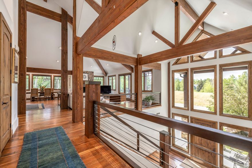 Discover timeless mountain living in this beautifully updated home in Park City's quiet and coveted Chatham Hills neighborhood. This stunning 4-bedroom, 4-bathroom home offers 4,809 square feet of thoughtfully designed living space on a beautifully landscaped 0.34-acre lot. Surrounded by open space in both the front and back, this residence offers the perfect blend of comfort, privacy, and access to nature. Step inside to find warmth and charm with exposed timber beams, vaulted ceilings, and rich hardwood floors. Natural light fills the spacious great room, where a dramatic fireplace creates a inviting gathering space. The gourmet kitchen is a chef's dream, featuring a 6-burner range, large island, and generous prep and storage space - perfect for entertaining. The main-level master suite is a serene retreat, complete with its own fireplace, private patio, and a beautifully updated ensuite bathroom boasting heated floors, a soaking tub, and a walk-in shower. Downstairs, the expansive family room with a second fireplace and bar offers the perfect space for relaxing or hosting guests. Step outside to enjoy peaceful evenings on the back patio, surrounded by mature landscaping and the quiet of nature. Out the front door you will find direct access to the Rail Trail-ideal for biking, hiking, cross country skiing and year-round outdoor enjoyment. Additional highlights include a new roof, central vacuum, new concrete driveway, and an oversized 3-car garage with room for all your gear and extra storage. This home truly has it all-style, space, serenity, and unmatched access to Park City's outdoor lifestyle.