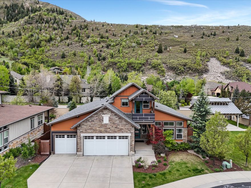 Experience elevated canyon living in this stunning rambler tucked away on a quiet cul-de-sac within a gated Little Cottonwood Canyon community. Ideally located less than 10 minutes from world-class ski resorts, this exceptional home offers the rare opportunity to be first up the mountain on powder days while still enjoying quick access to shopping, dining, freeway connections, and the vibrant East Sandy commercial corridor.  Built by Garbett Homes as The Chandler floor plan and featured in the 2016 SLHBA Parade of Homes, this 4-bedroom, 3-bath residence offers 5,583 square feet of thoughtfully designed luxury on .22 acres. The main level showcases soaring ceilings, rich hardwood flooring, abundant natural light, and an open-concept layout designed for both everyday comfort and effortless entertaining.  The chef's kitchen is a true showpiece, complete with high-end appliances, a walk-in pantry, quartz countertops, and seamless flow into the spacious living and dining areas. The expansive main-floor primary suite offers a private retreat with a spa-inspired en-suite bath featuring a separate tub, oversized shower, and an impressive walk-in closet.  Downstairs, the finished basement continues the home's generous scale with high ceilings, two additional bedrooms with walk-in closets, a convenient kitchenette, and flexible unfinished space ready to become a media room, home theater, gym, or office. An upstairs loft with its own balcony adds even more versatility - ideal as a reading lounge, yoga studio, creative space, or peaceful retreat.  Built to the highest standards of efficiency, this ENERGY STAR and AirPLUS certified home blends luxury with sustainability, offering exceptional comfort and performance. A spacious 3-car garage with additional washer/dryer hookups adds everyday convenience to this truly one-of-a-kind property.  Luxury, function, energy efficiency, and unbeatable access to Utah's iconic mountain lifestyle.  This is canyon living at its finest.  All figures are provided as a courtesy estimate only.  Buyer is advised to obtain an independent measurement.