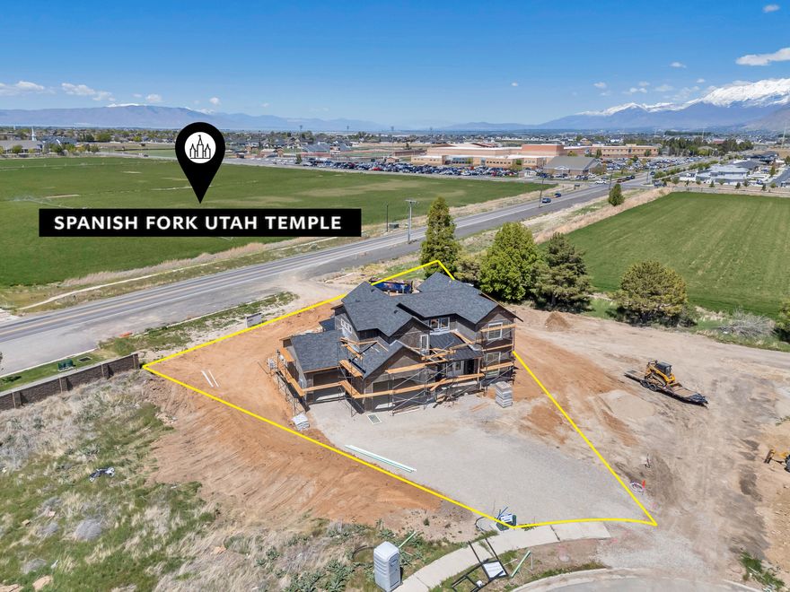 This beautiful home is under construction directly across the street from the newly announced Spanish Fork Temple site. Thoughtfully designed with 5,602 square feet on a .41-acre lot. The main level offers main level living with 10-foot vaulted ceilings, an office that can easily convert to a bedroom, and a primary suite with walk-in closet and dedicated laundry. The home includes a 3-car garage for ample parking and storage. Each level of the home includes its own laundry facilities for added convenience. Upstairs you will find four additional bedrooms, two full bathrooms, a large landing area, and another laundry room. The basement features a 2-bed/2-bath ADU with its own separate entrance, while the remaining basement space is available for owner use, providing maximum flexibility for your needs. Location is exceptional with Maple Mountain High School directly across the street for an easy walk to school. The home is just 5 minute drive from I-15 freeway access and to all the shopping and dining Spanish Fork has to offer. Estimated completion is June-July 2026.