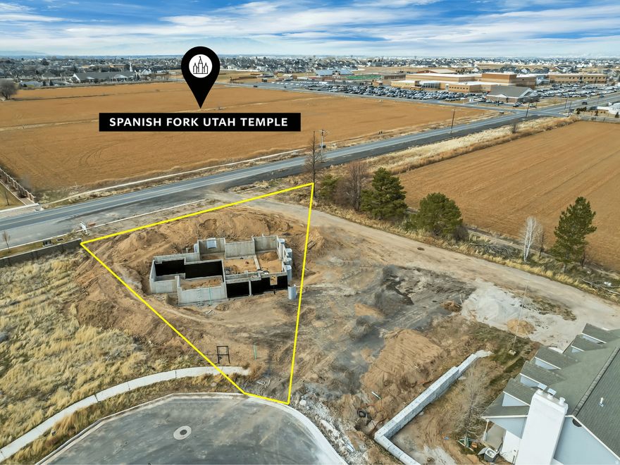 This beautiful home is under construction directly across the street from the newly announced Spanish Fork Temple site. Thoughtfully designed with 5,602 square feet on a .41-acre lot. The main level offers main level living with 10-foot vaulted ceilings, an office that can easily convert to a bedroom, and a primary suite with walk-in closet and dedicated laundry. The home includes a 3-car garage for ample parking and storage. Each level of the home includes its own laundry facilities for added convenience. Upstairs you will find four additional bedrooms, two full bathrooms, a large landing area, and another laundry room. The basement features a 2-bed/2-bath ADU with its own separate entrance, while the remaining basement space is available for owner use, providing maximum flexibility for your needs. Location is exceptional with Maple Mountain High School directly across the street for an easy walk to school. The home is just 5 minute drive from I-15 freeway access and to all the shopping and dining Spanish Fork has to offer. Estimated completion is late 2026.