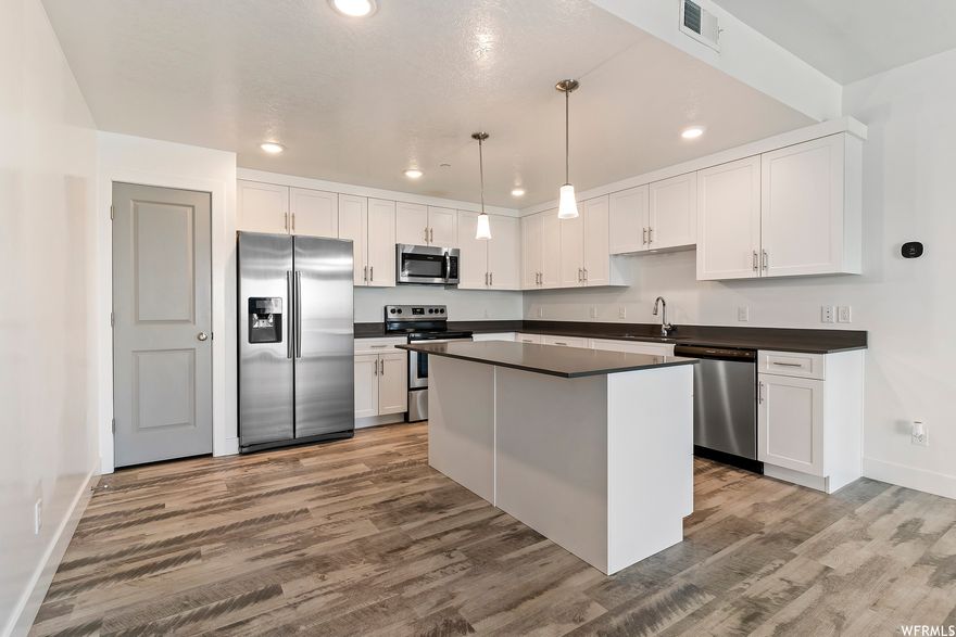 Like new 3 bedroom/2 full bath condo conveniently located in Clearfield! This unit features laminate flooring throughout the family room and kitchen. Large kitchen with shaker style cabinets and granite countertops. 9' ceilings and a private covered balcony. Plenty of amenities to enjoy including pool/hot tub clubhouse, dog park, playground plus HOA pays water/sewer/trash. Easy access to Hill AFB and I-15. Elementary, Jr. High and High School all within a mile!