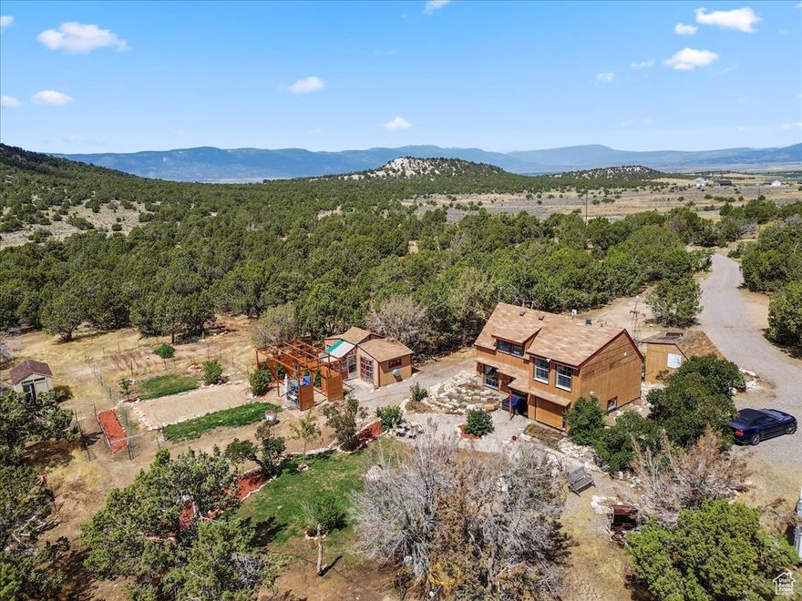 Don't miss this idyllic hideaway in the heart of Sanpete County! Just three miles south of historic Spring City, this 15.9-acre property offers the perfect blend of peace, privacy, and a true back-to-the-land lifestyle. Surrounded by juniper trees and sweeping mountain views, the home sits privately with no close neighbors in sight. This property is so unique-inside and out. As you explore, you'll come across treasures you aren't even sure if you've discovered before-little quaint details that make this property a true rare find. The home has been thoughtfully updated with granite countertops, new cabinetry, and unique custom touches throughout. A flexible mud/bonus room provides space for a home office or additional bedroom, while upstairs offers two cozy bedrooms and a full bath. A pellet stove adds warmth and charm, keeping you cozy on cold winter nights. Step outside to enjoy sunsets from the cobblestone patio and take in the wide-open skies. The land is fully fenced and currently set up for horses, with 5' panels, a canvas-style barn, and plenty of acreage to train, ride, or simply explore. A private well ensures reliable water, and a chicken coop with added storage stays with the property. Multiple exterior storage sheds provide ample space for tools, tack, and equipment. A well-maintained garden area is set up and ready for you to grow your own, along with established fruit trees and grapevines.  Summer living is made easy with a level pad of sand for the 12" X 22" above-ground pool (included), and a pergola-covered sitting area-perfect for BBQs and entertaining.  Adding to its uniqueness, the property even features its own personal weather station.  Beyond the property's own recreational features, you'll find the Wildlife Management Area just across the street, with miles of trails for horseback riding and endless exploring. If you've been dreaming of wide-open skies, breathtaking sunsets, and a property where you can breathe, roam, and truly live close to the land, this is the one.