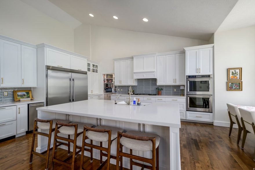 Welcome to the prestigious Bellevue community. This magnificent home boasts 5,452 sqft, 6 bedrooms, 4.5 bathrooms, 3 car garage, 2 kitchens, and a walkout basement.  Main Level-Completely remodeled in 2022 with the following upgrades: Hardwood floors, custom millwork, commercial freezer and refrigerator, quartz countertops, Bosch gas stove, Bosch dishwasher, new Kitchen Aid double ovens, walk in butler pantry, custom master closet with stackable washer and dryer. Solid core doors and upgraded hardware throughout. Large mudroom with lockers. Large office/homework room space.   Basement- Spacious family room, second kitchen, walk-out with large windows and natural light. Built in bunkroom that sleeps 6! 2 large bathrooms and 4 bedrooms in the basement. Cold storage space, flex room currently used as home gym space, and second laundry.  The front yard was completely re-landscaped with all new sprinkler system, sod, pavers, trees and perennials! Backyard has a large covered deck that is perfect for entertaining, gas line for BBQ, hot tub, firepit and in ground trampoline.
