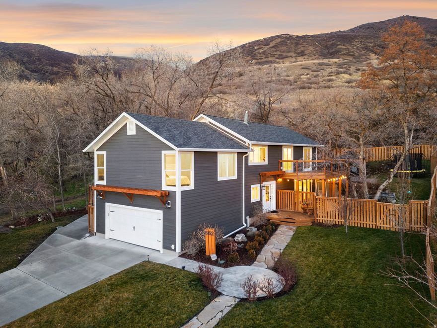 Extensively reimagined and renovated inside and out, this exceptional Farmington Bench home offers the rare combination of an established setting with the comfort and efficiency of a much newer residence. Nearly every surface and system has been thoughtfully upgraded, allowing buyers to move in with confidence and enjoy the home immediately.  Opportunities on the highly sought-after Farmington Bench rarely offer this level of views, setting, and location. Blending character with modern comfort, this home provides unmatched access to the outdoors. Located within Farmington's established Historic District, you are just steps from Farmington Pond, Farmington Canyon, and miles of hiking, mountain biking, ATV, and snowmobile trails, delivering year-round recreation right outside your door.  As part of the comprehensive 2023 renovation, the home is filled with natural light, timeless character, and curated design details. The upper level features four bedrooms and three bathrooms, including a stunning primary suite with a modern bath and private walkout to the large deck. An inviting family room with a fireplace creates a warm gathering space, perfectly positioned to capture incredible sunset views.  Designed for both everyday living and effortless entertaining, the main floor offers a custom kitchen and dining area, welcoming gathering space, flexible bedroom or office, and an expansive mudroom. Hundreds of thousands were invested in a comprehensive renovation, creating a home that would be difficult to replicate at today's construction costs. The scope of improvements goes far beyond cosmetic updates, delivering meaningful upgrades to both the design and functionality of the home.  Step outside to enjoy two private covered patios ideal for relaxing or hosting. Additional highlights include new Hardie board siding, ductless mini-split heating and cooling, and heated floors in the mudroom and bathrooms.  The outdoor setting is exceptional, offering a private slice of nature with sweeping mountain, valley, and lake views from multiple vantage points. Peaceful and scenic, the property delivers a retreat-like atmosphere while remaining just minutes from Lagoon, Station Park, shopping, dining, convenient freeway access, and easy reach to Salt Lake City.  With extensive updates, remarkable scenery, and a coveted Bench location, properties like this rarely become available at this level of renovation.  Owner Agent. Buyer to verify all information. Please refer to the renovations and upgrades list for full details.