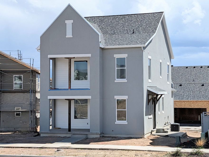 3% Preferred Lender Incentive! Almost completed Brand-New Home! Step inside to discover 9-ft ceilings on every level, creating a bright and open atmosphere throughout. The main level features a dedicated office or bedroom ideal for remote work or study, and flows seamlessly into an upgraded kitchen complete with high-end finishes perfect for both everyday living and entertaining. Upstairs, the spacious primary suite includes a private balcony. Large windows throughout fill the home with natural light, enhancing the open spaces of this thoughtfully designed layout. Located in the desirable Watermark Village in Daybreak community, you'll enjoy access to parks, trails, and the Watercourse all just minutes away. Estimated April-May 2026 Completion.