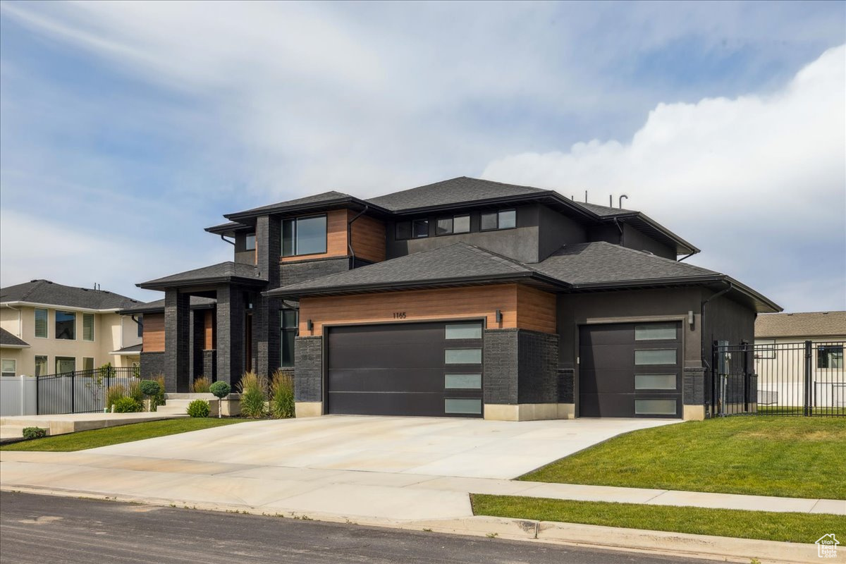 This is a rare opportunity in the nearly sold-out Riverwalk luxury community. This modern, fully custom 2-story home sits on a private 0.4-acre lot and delivers unmatched high-end amenities inside and out. The main floor showcases a designer primary suite with fireplace, spa-inspired bath, oversized shower, modern soaking tub, and a massive custom build out in the Primary closet. The kitchen features a butler's pantry with quartz, face-framed shelving, and built-in outlets. At the heart of the home, the expansive family room features soaring 18-ft ceilings and a dramatic floor-to-ceiling tile fireplace surround-a stunning complement to the chef's kitchen with quartz counters, custom cabinetry, and oversized laundry + mudroom. Upstairs offers two bedrooms, a full bath, and an open loft and playroom that could easily be converted into a 3rd bedroom. The finished basement provides a private theater, gym space, guest suite, and abundant storage. Step outside to enjoy a 40-ft wide covered patio, post-tension pickleball/tennis court, enclosed outdoor gym, Bullfrog spa, sauna, and fully fenced yard. Riverwalk residents enjoy access to a private pool, clubhouse, parks, and the Jordan River trail system-all for only $55/month. With its striking exterior of modern black brick, low-maintenance wood accents, and professional landscaping, this Symphony masterpiece stands as a true statement of luxury, exclusivity, and lifestyle just minutes from the Point of the Mountain tech hub.