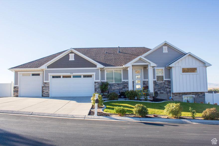 Welcome to this exceptional 3-bedroom, 2-bathroom home. This property combines comfort with functionality that includes an  impressive 30x70 detached garage that's practically a car enthusiast's dream come true. With (4) 10x10 bay doors and a recreational vehicle bay door, this versatile space can accommodate 5 additional vehicles while maintaining the workshop functionality. 3 heaters and 2 swamp coolers ensure year-round comfort, making this the perfect space for hobbies and storage. The exterior showcases a beautiful Xeriscape landscape that celebrates the natural desert environment while minimizing maintenance requirements. Mountain and Valley views provide a stunning backdrop. Both the main residence and shop feature Jellyfish Lighting. The ample parking accommodates multiple vehicles with ease, while the substantial outdoor space offers endless possibilities for recreation and relaxation. Located within Eagle Mountain's growing community, you'll find various recreational opportunities. The property strikes an ideal balance between suburban convenience and rural tranquility, offering space to pursue your passions while staying connected to essential amenities. This unique property offers both residential comfort and exceptional workspace functionality, making it ideal for those who appreciate having room to grow and create.