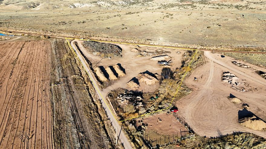 This rare commercial offering provides an established compost, green-recycling, and soil-amendment business positioned for substantial growth. Situated on approximately 6 acres, the property includes a small portable office, a large operational yard, power, and extensive compost and soil-related inventory. For a new owner-operator, this could be an opportunity to take the building blocks in place and create a business with strong market demand. This site offers proven production capacity and scalable potential. Equipment and Inventory Included.  2014 Powerscreen Trakpactor 320 SR Impact Crusher  Refurbished and ready for continued production.  2008 Peterson Horizontal Grinder  Refurbished; requires new motor.  Substantial wood-compost inventory ready for processing and distribution. Soil Resources & Lease Opportunities Adjacent acreage, available for lease, provides access to native iron-rich sandy loam soil known as "Ferrozite." Lab testing from Stukenholtz Laboratories indicates high levels of iron and essential nutrients including N, P, K, S, Z, and M. This soil has been used as a slow-release micronutrient source that supports plant vigor, chlorophyll production, and enzyme and nitrogen-fixation functions. Operational Strengths The business focuses on producing high-quality soil and wood compost, recommended for:  Raised beds  Lawn topsoil blends  Gardens and flower beds  Agricultural soil amendment  Commercial or residential landscape supply production The demand for soil-health products continues to rise alongside the growth of gardening, hobby farming, and regenerative agriculture across Utah. This operation is well-positioned to supply this expanding market. Infrastructure & Expansion Potential  Power on site with ample yard space  Room for a bagging operation, enabling broader product distribution  Nearby access to major interstate corridors (I-70 & I-15)  Space to increase green-recycling capacity  Ability to scale both wholesale and retail supply chains