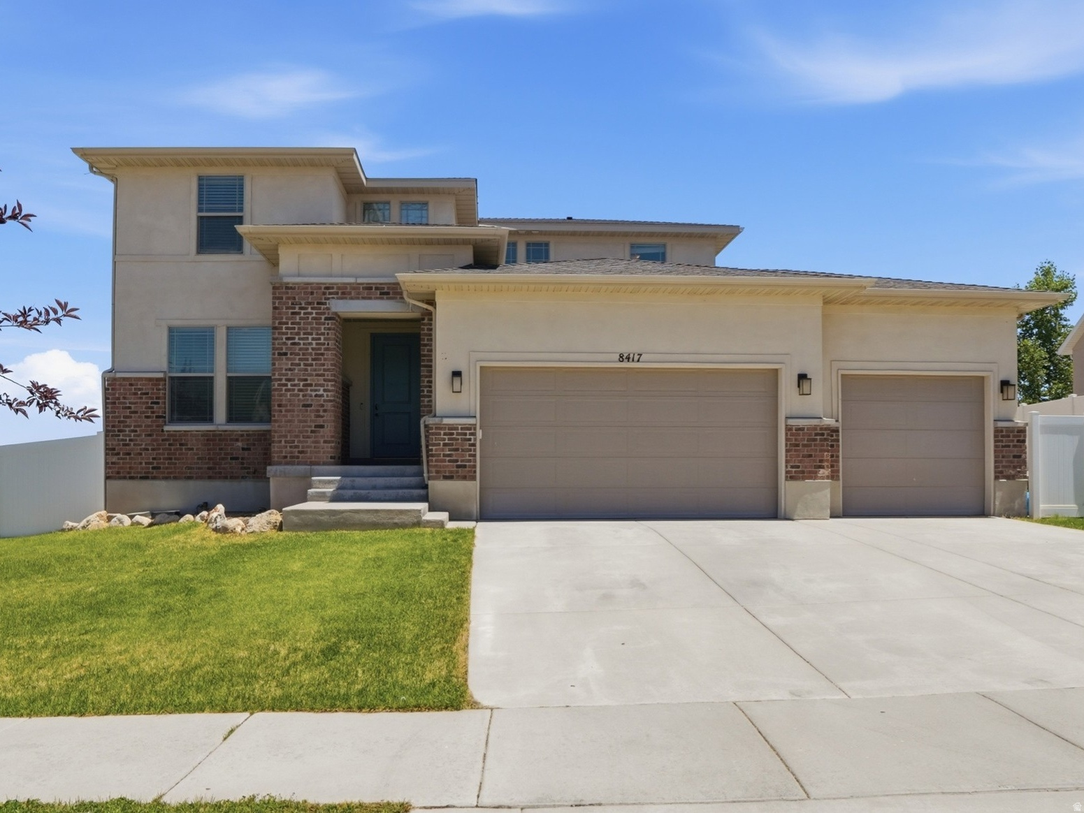 Contemporary exterior with a two-car garage and a paved driveway