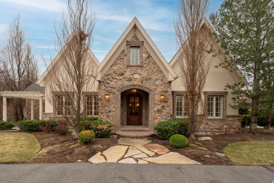 Charming stone and brick European style with soaring ceilings, wide-open spaces and truly fabulous millwork and finishes. Many tasteful updates by the original owner who has loved this home. Huge .65 acre lot with privacy, mountain views and a wonderful pool and spa! There is a detached oversized RV/boat garage plus an oversized attached double. Play court, circle drive and mature, park-like landscaping add appeal. The spaces include a grand entry, elegant formal living and dining rooms, a main floor office and spacious family rooms main and down. The main level primary has a freshly redone luxury European bath. The kitchen is all white, quartz slabs, and a great bay window overlooking your own private park. There are main and lower laundry facilities. Four large bedrooms are down. There is a ton of storage. Note the top floor secluded theatre! This house has it all, plus the ultimate location!