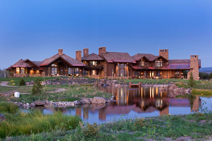 Timpanogos Ridge Estate is a rare opportunity to own a private 160-acre mountain retreat in one of Utah's most exclusive communities.  Perched atop a commanding ridgeline, the estate captures sweeping views of Mount Timpanogos, the Heber Valley, and surrounding mountains. Evenings are defined by alpenglow skies reflecting across a private swimmable pond with sandy beach and dock, creating a setting that is both peaceful and unforgettable.  The 17,500+ sq ft residence, built by Cameo Homes and designed by Paula Berg, showcases a level of craftsmanship rarely seen, hand-finished woodwork, custom iron detailing, and thoughtfully designed spaces that balance scale with warmth. Grand living areas and seamless indoor-outdoor transitions create an effortless environment for entertaining and everyday living.  Outdoor living is at the heart of the property, with multiple patios, fire features, outdoor kitchens, and expansive lawns, all connected to over 60 miles of private trails that invite year-round adventure directly from your doorstep.  Located within the gates of Wolf Creek Ranch, just 25 minutes to Deer Valley's East Village, the estate offers a rare balance of complete privacy and convenient access to world-class recreation.