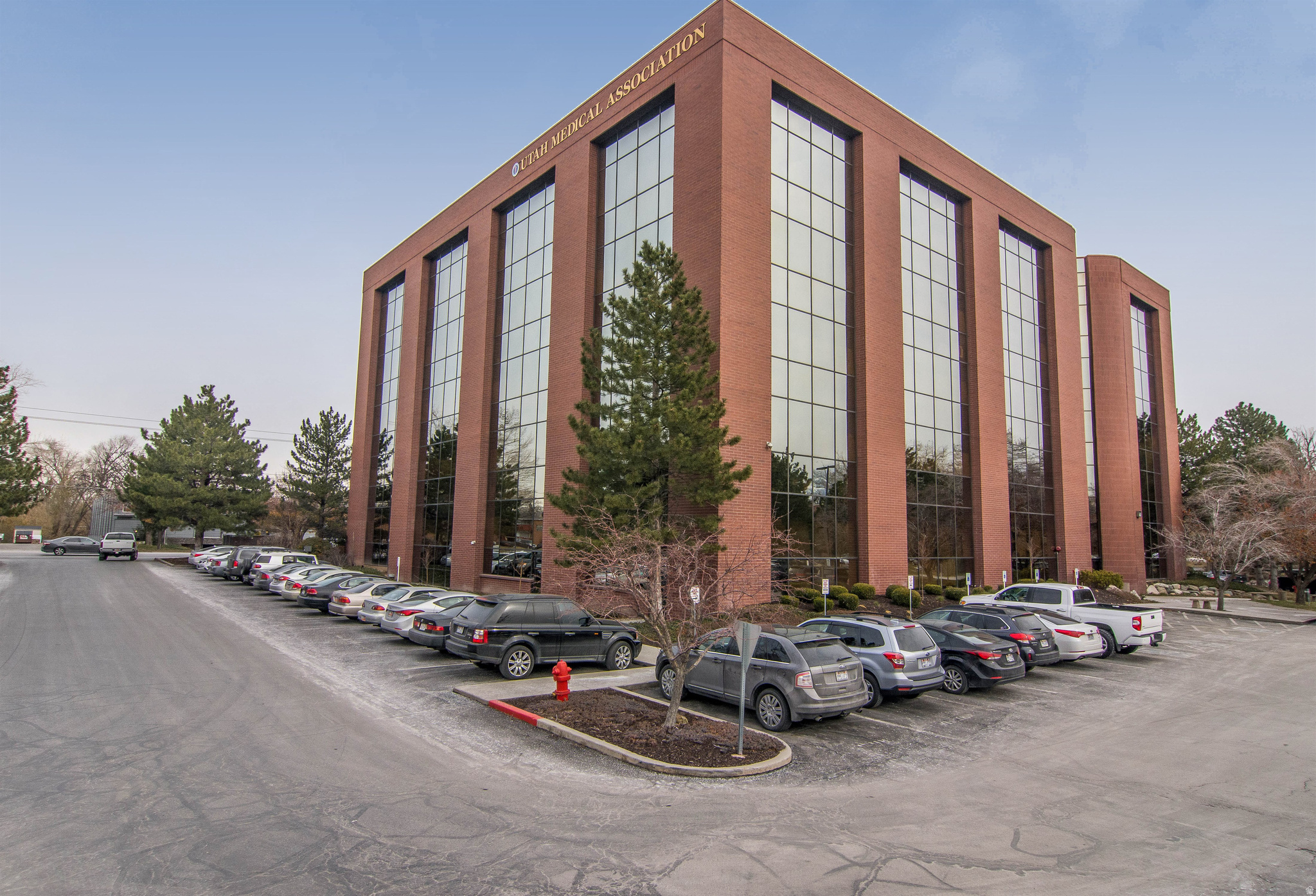 View of building exterior with uncovered parking