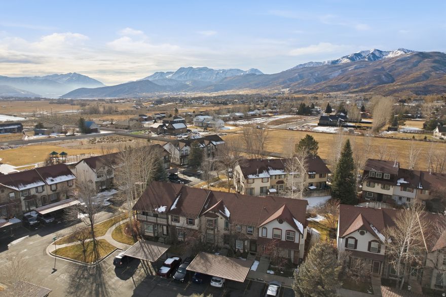 There's a certain kind of peace you only find in Midway-the kind that settles in your chest the moment you see the mountains open around you. This updated condo in The Hamlet gives you a place to land in the middle of all that beauty, a home that feels warm, intentional, and ready for the life you want to build. The kitchen is the heart of it all, thoughtfully refreshed with quartz countertops, a gas range, a tasteful backsplash, a water softener, and a new water heater-a space that invites slow mornings, shared meals, and the kind of conversations that stretch long after the plates are cleared. Step outside and the world opens up. Walk the quiet streets of Midway, where neighbors wave, festivals fill the town square, and the mountains feel close enough to touch. Spend your weekends soaking in the Homestead Crater, wandering the trails of Wasatch Mountain State Park, skiing or tubing at Soldier Hollow, or paddling across the glassy water of Deer Creek Reservoir. Here, adventure isn't an event-it's a rhythm.