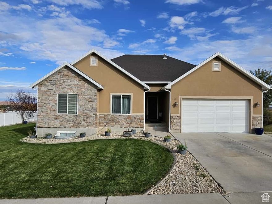 This 5-bedroom, 3-bathroom single-family home in Roosevelt offers 3468 square feet of modern comfort. Built in 2011, the property features an attached two-car garage with an electric vehicle charging outlet. Enjoy fiber high-speed internet and easy maintenance with fully landscaped grounds, automatic sprinklers, and drip irrigation. Two sheds provide additional storage (one of which is a kiln). Located across from Roosevelt City Constitution Park, you'll have access to ball fields, a skate park, walking/running paths, and annual events. Roosevelt is a 30-minute commute from Vernal and Duchesne, and 2 hours from Heber, with plenty of outdoor activities nearby in the High Uintah Mountains. Don't miss this opportunity for a turnkey home in a vibrant community. Schedule your showing today! Square footage figures were obtained from county records. Buyer is advised to verify all information and do their due diligence.